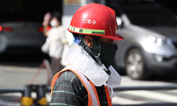 폭염이 계속된 지난달 4일 대구 중구의 한 공사장에서 근로자가 목에 얼음주머니를 두르고 더위를 이겨내고 있다. (사진=연합뉴스)